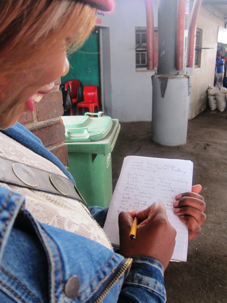 An informal trader representative taking meticulous notes from the workplace safety audit. Image: Tasmi Quazi.