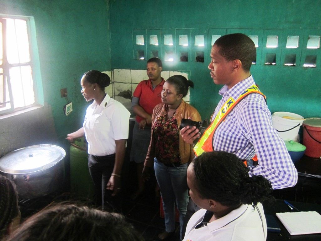 The workplace-safety audit delegation inspecting a food cook's stall. Image: Tasmi Quazi.
