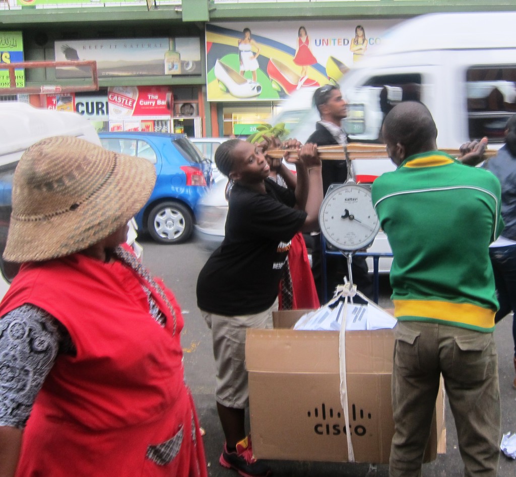 City official, Pumla Jali, weighing a box of recyclables sold to the "middle-agent". Photo: Tasmi Quazi.